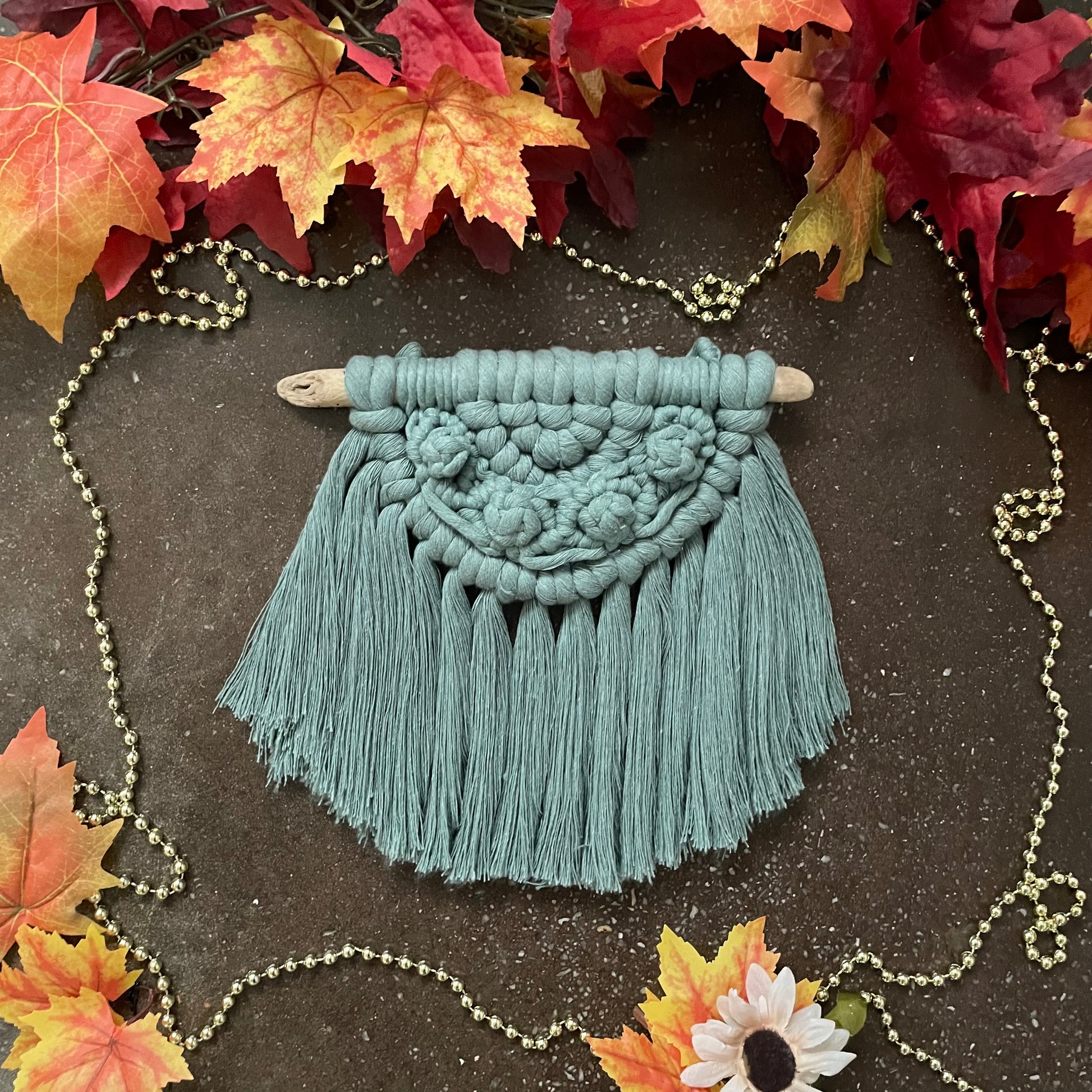 Sweater Weather Macramé Wall Hanging Laurel On Cement With Leaves