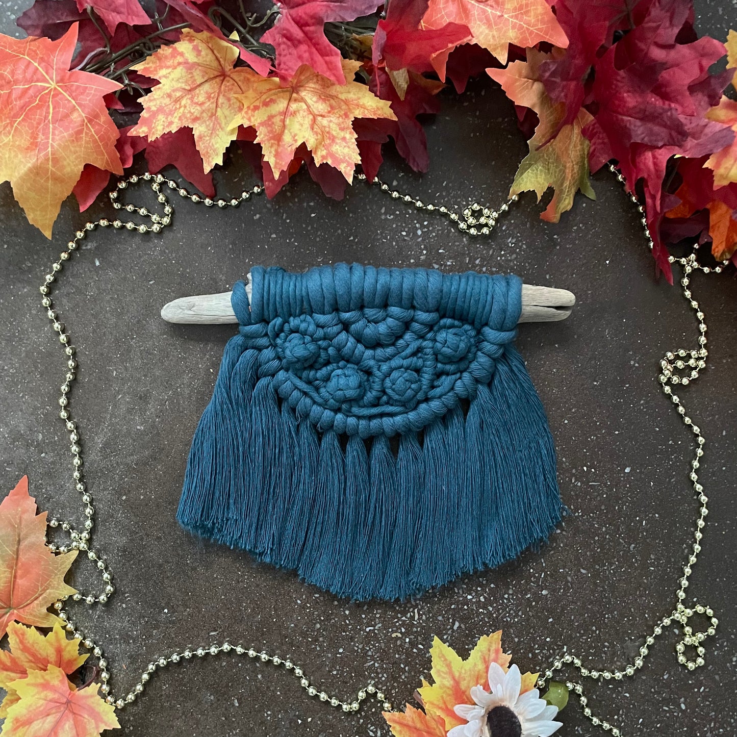 Sweater Weather Macramé Wall Hanging Peacock On Cement With Leaves