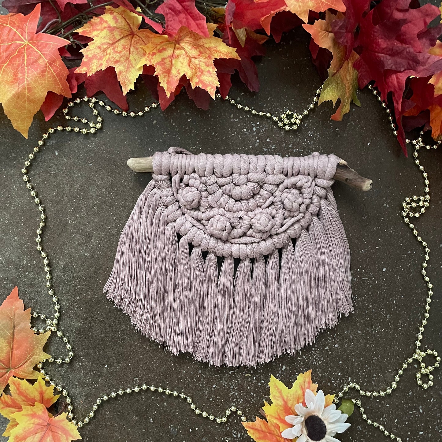 Sweater Weather Macramé Wall Hanging Mauve On Cement With Leaves