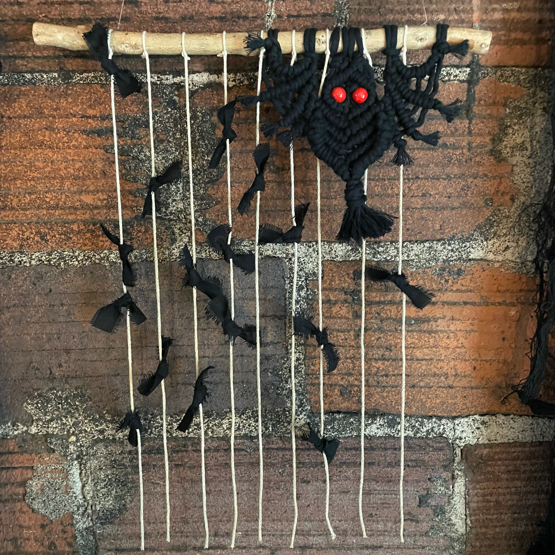 "Imminent" Bats Macramé Wall Hanging on brick wall