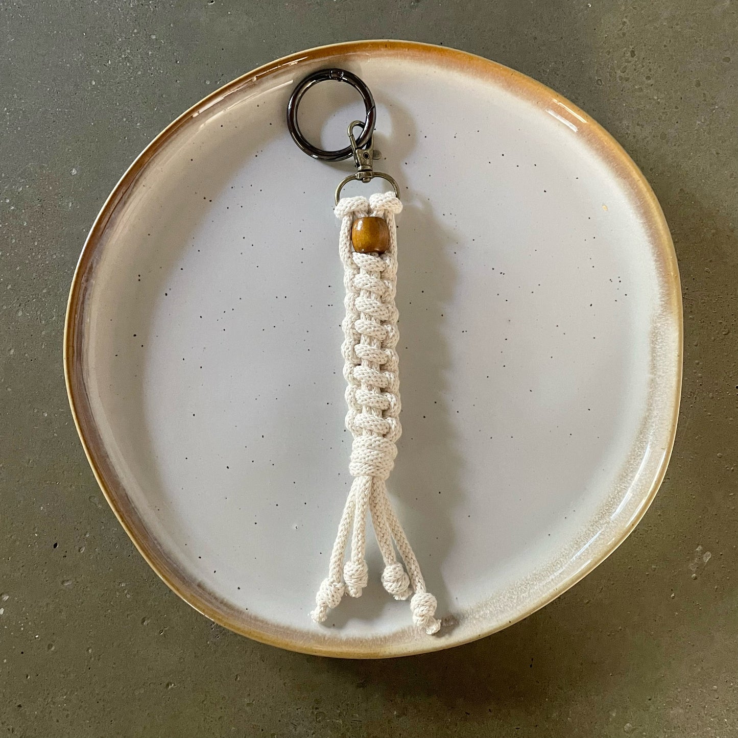 Key Chain centered on dinner plate. Straight ladder style in Natural White