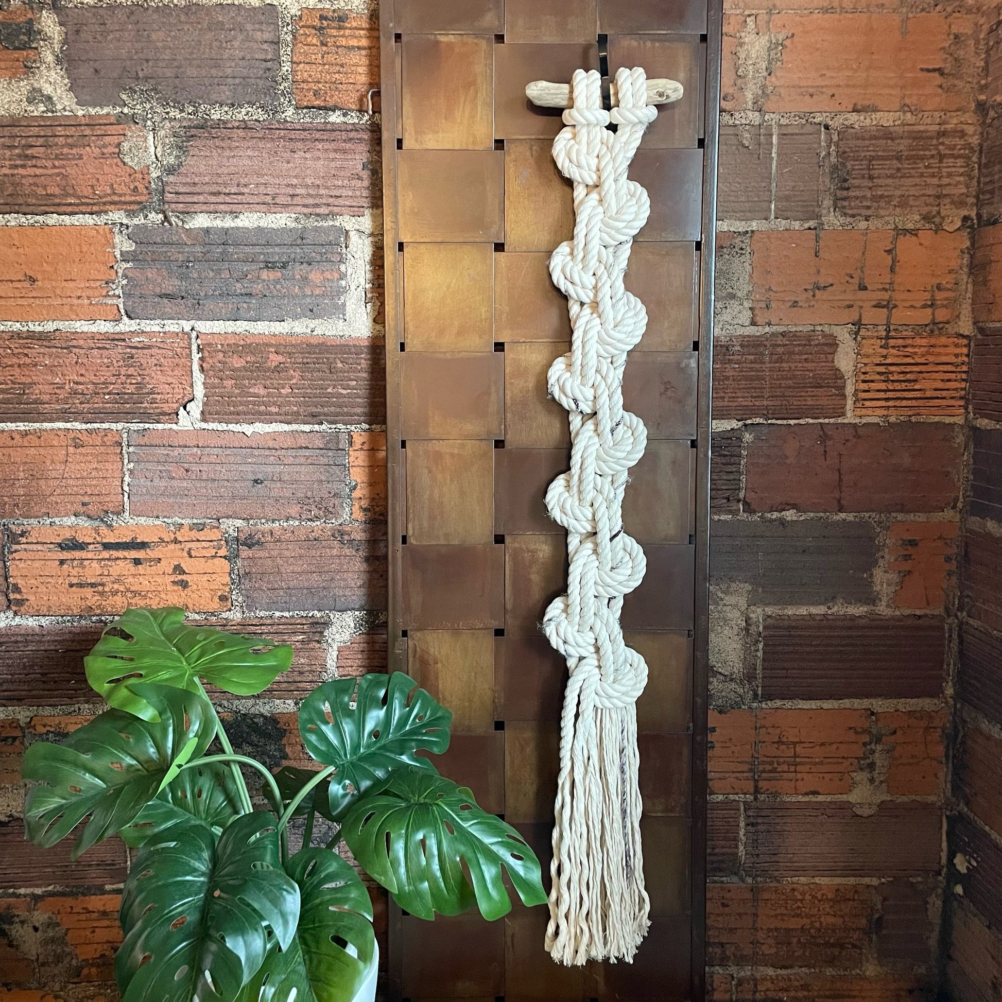 Cascade Macrame Wall Hanging On Brick Wall