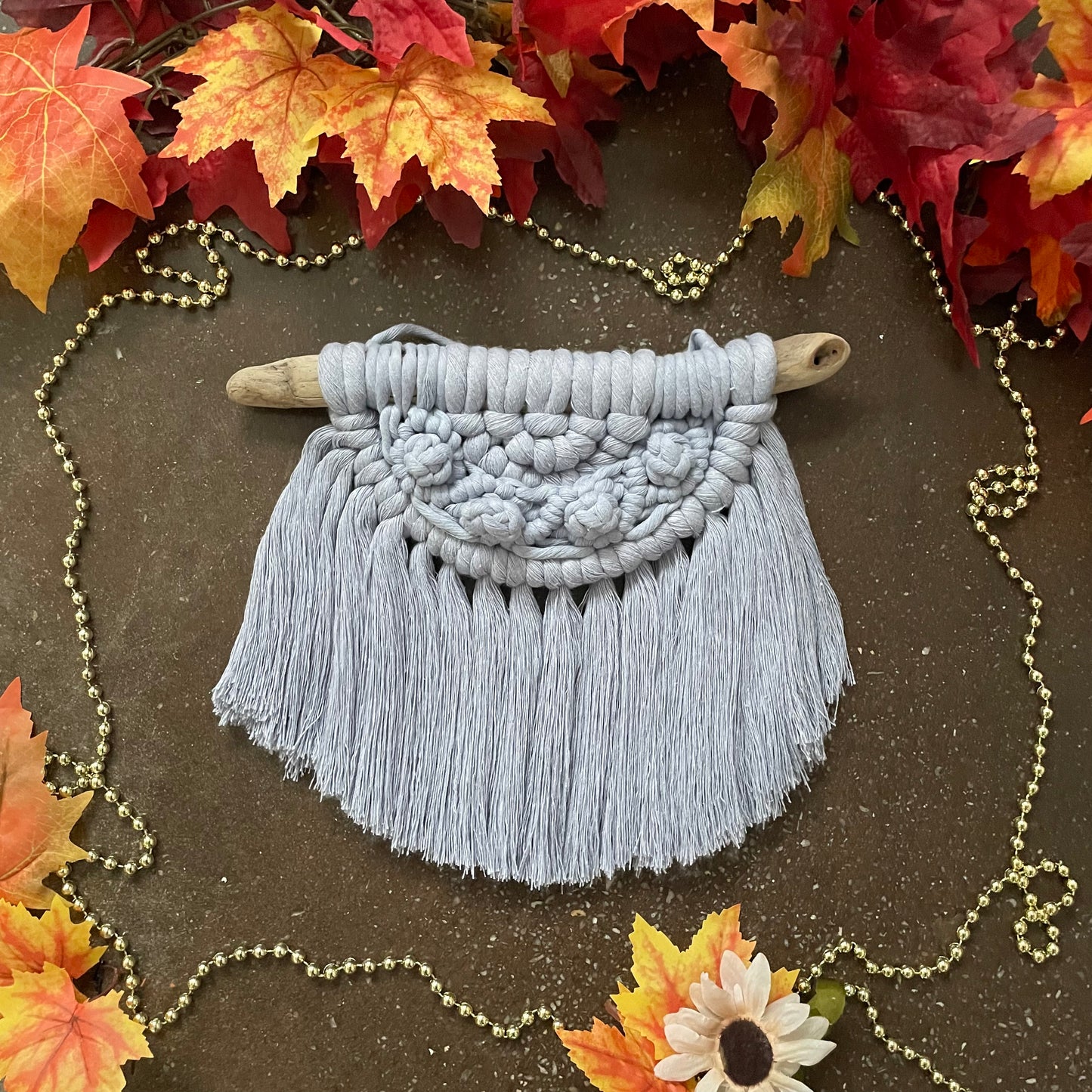 Sweater Weather Macramé Wall Hanging Iris On Cement With Leaves