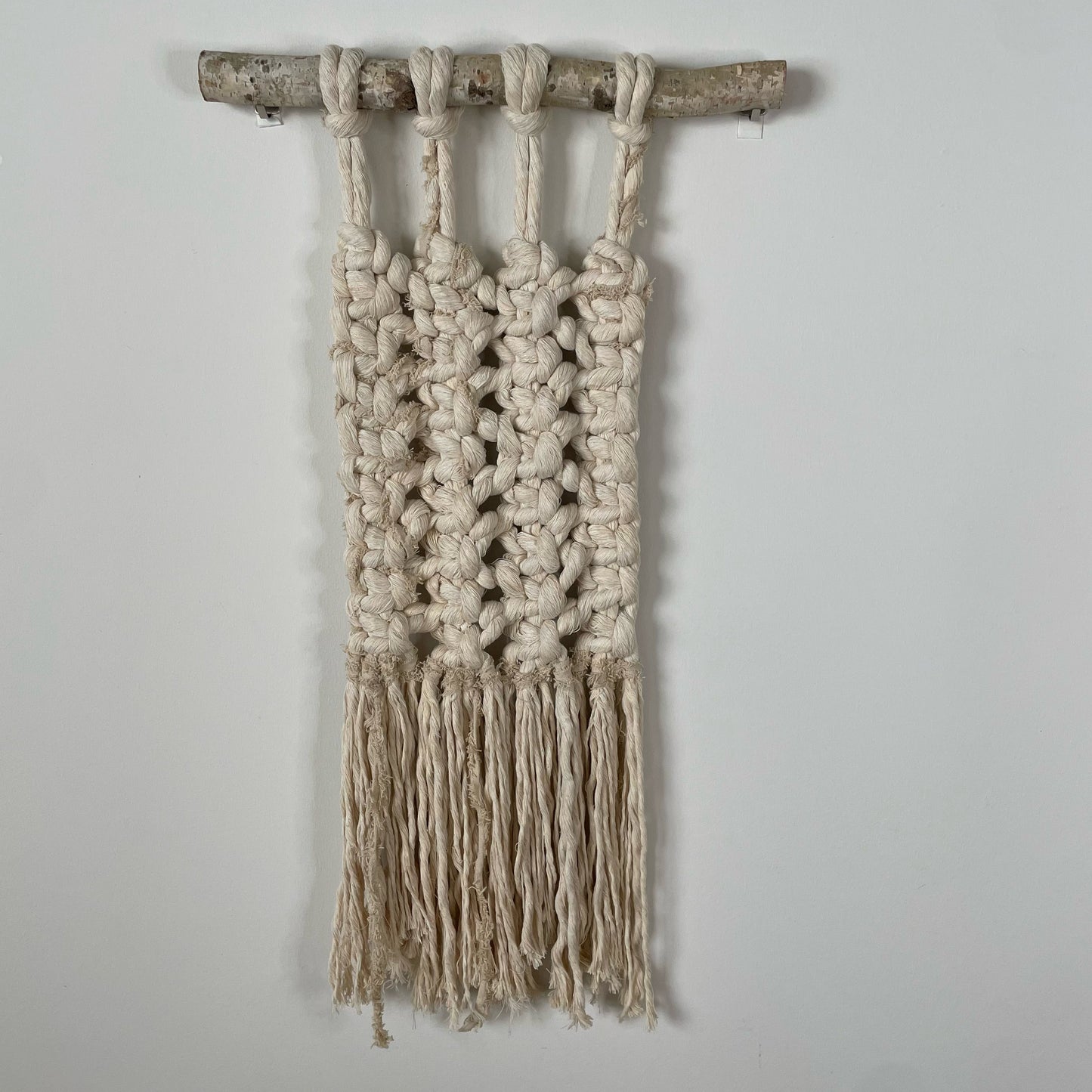 "Bones" Macramé Wall Hanging on white wall